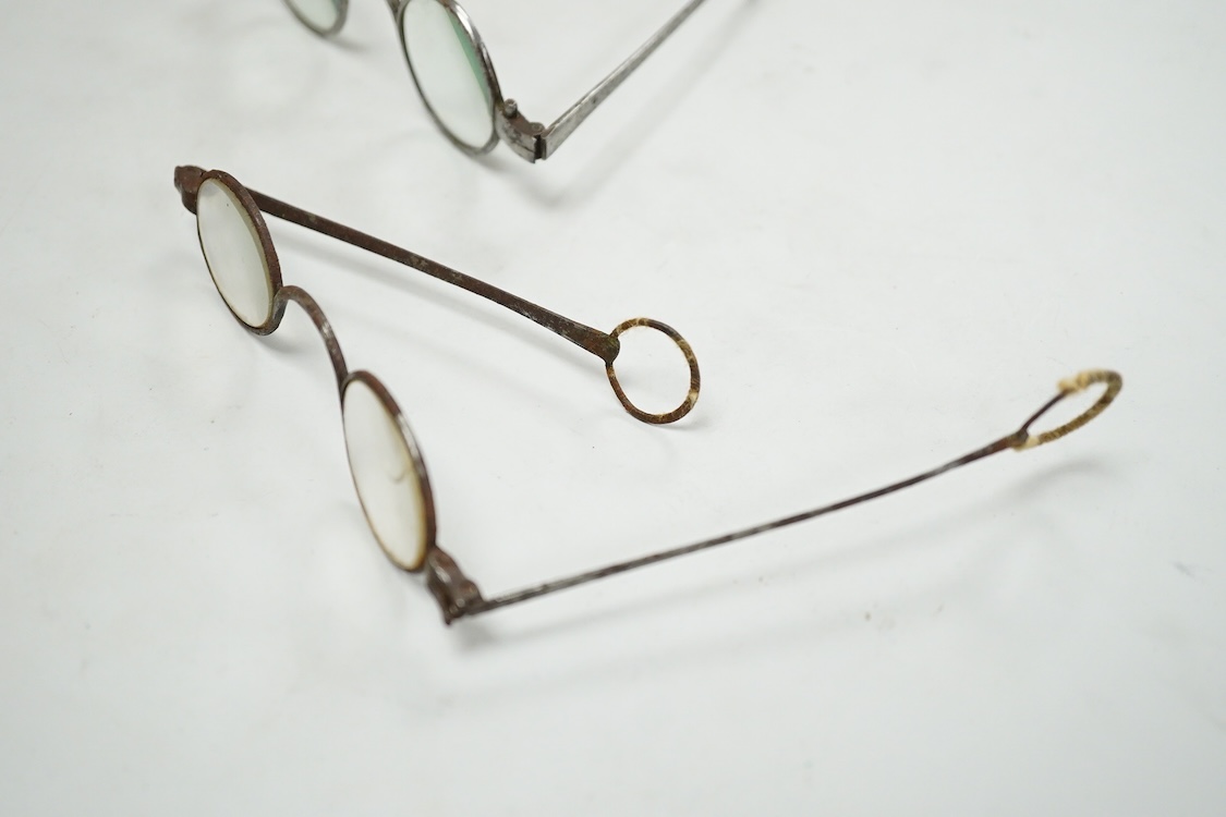 A pair of 18th century steel temple spectacles, a similar pair of iron spectacles, with written note dating them to 1796, and a pair of German? brass framed spectacles with green tinted lenses (3)